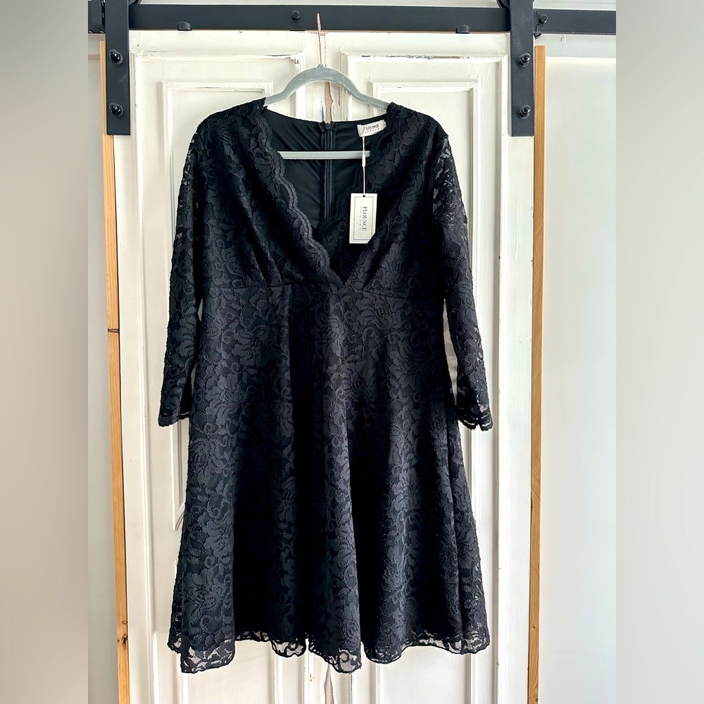 Beautiful and elegant black lace evening dress. Knee length.